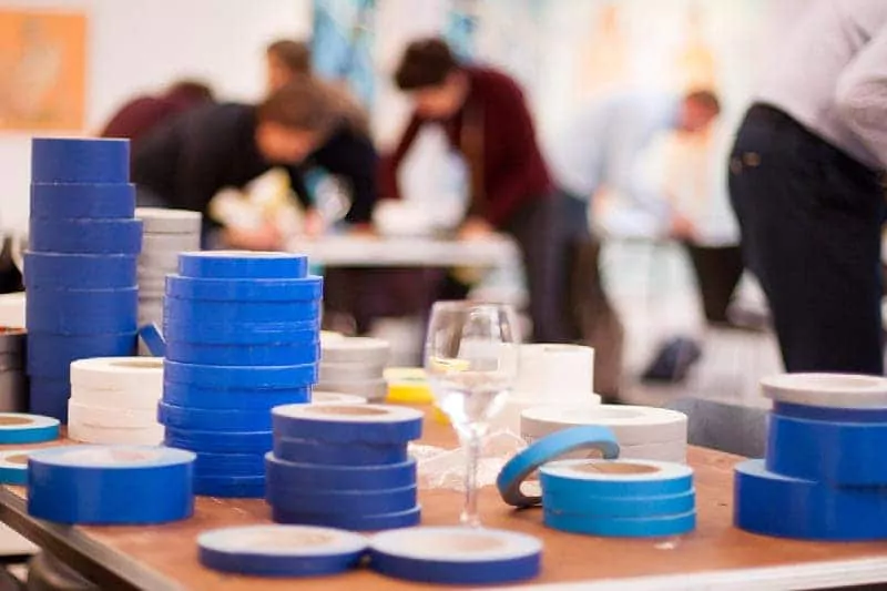 Teilnehmer des Tape-Art-Workshops machen ihre ersten Handgriffe